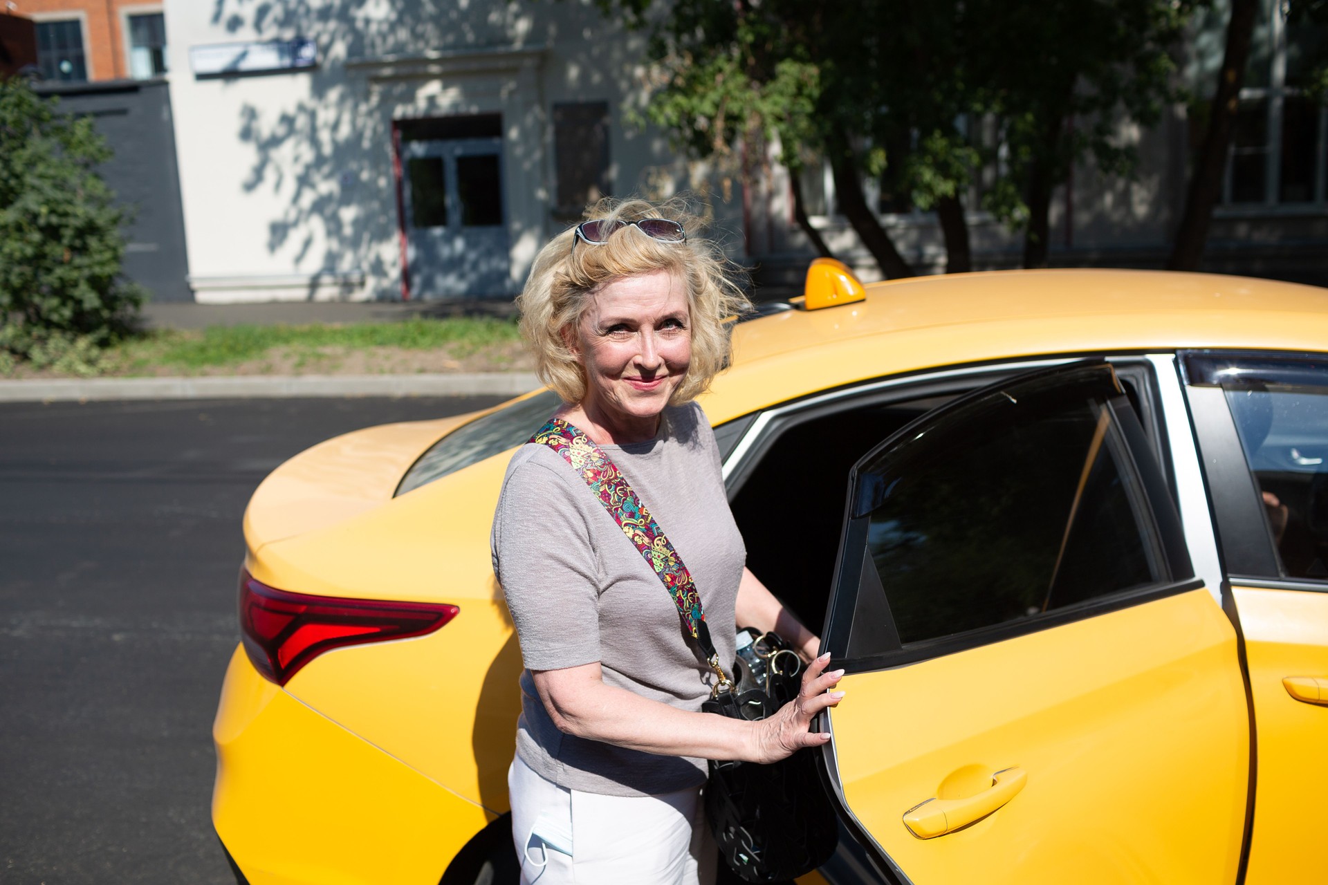 Elderly caucasian old aged woman take taxi car vehicle ride.